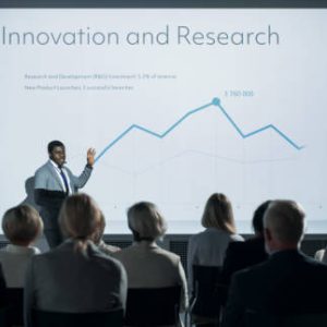 istockphoto-1757815878-612×612 Corporate Event: Black Male Tech CEO Giving Presentation To Colleagues or Investors In the Conference Room Of Innovative Startup Office. Successful African Man Talking About Business Vision, Mission.